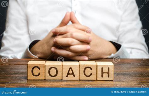 The Inscription Coach And A Man Sitting With His Hands Clasped In A