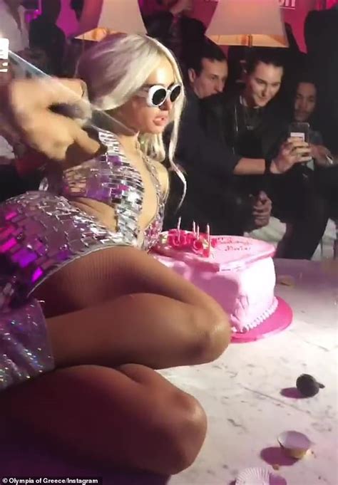 Paris Hilton stomps on her 38th birthday cake while dancing on table... ahead of Anti V-Day DJ ...