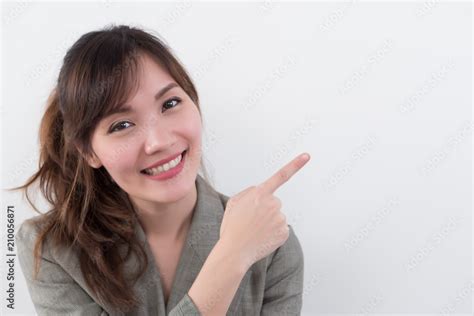 happy girl pointing up; portrait of cheerful smiling woman points hand ...