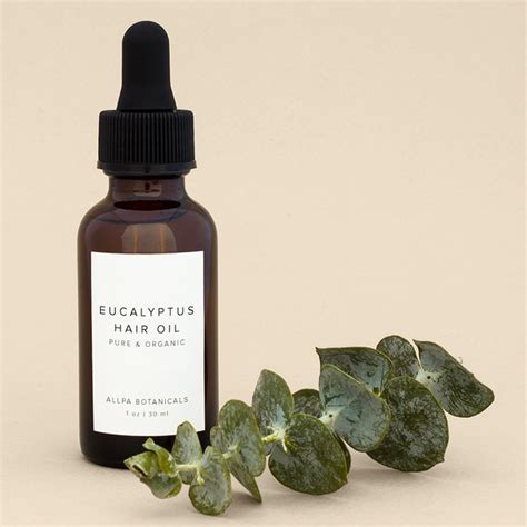 a bottle of eucalyptus eucalyptus face oil next to a small green plant on a beige background