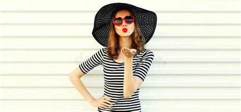 Portrait Of Beautiful Young Woman Blowing Her Lips With Red Lipstick