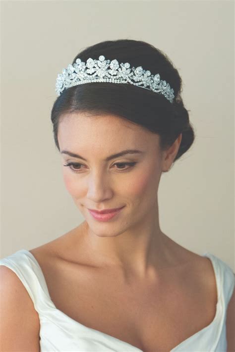 A Woman In A White Dress Wearing A Tiara