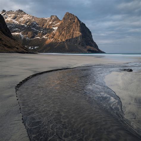 Mountain Peaks Rise Over Kvalvika Beach License Image 70521557