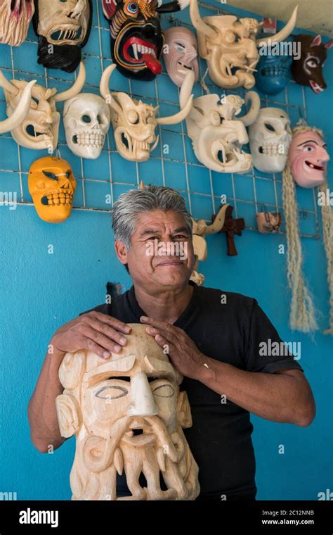 Wood working artist Felipe Horta holds a traditional Purepecha mask ...