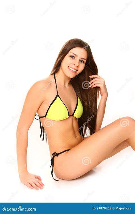 Mujer Joven En Un Bikini Amarillo Que Se Sienta En El Fondo Blanco