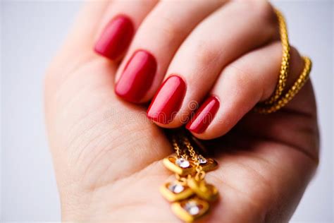 Nails Design Hands With Bright Red Spring Manicure On Grey Background