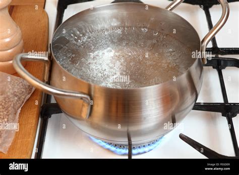 Boiling Water Into Saucepan Cooking Buckwheat Groats On Gas Stove