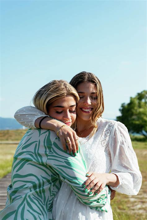 Smiling Female Best Friends Hugging Each Other Photograph by Cavan Images - Pixels