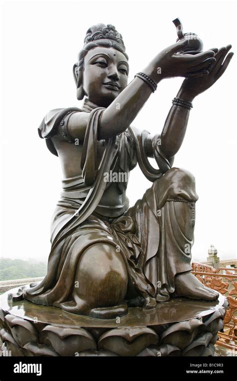 Buddhist Statue Making Offerings To The Tian Tan Buddha On A Misty Day