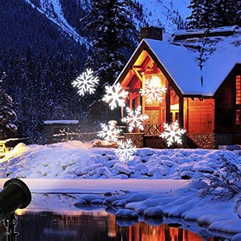 A House Is Lit Up With Christmas Lights And Snowflakes In Front Of It