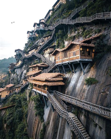 Wangxian Valley With Houses Hanging On Its Cliff Themindcircle