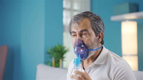 Old man with chronic illness wears respirator. 32516526 Stock Video at