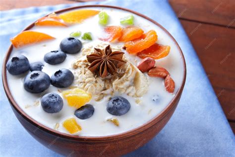 premium photo oatmeal porridge  milk fruits  peanuts  blue