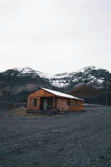 Wooden Cabins on Hill in Mountain Landscape · Free Stock Photo