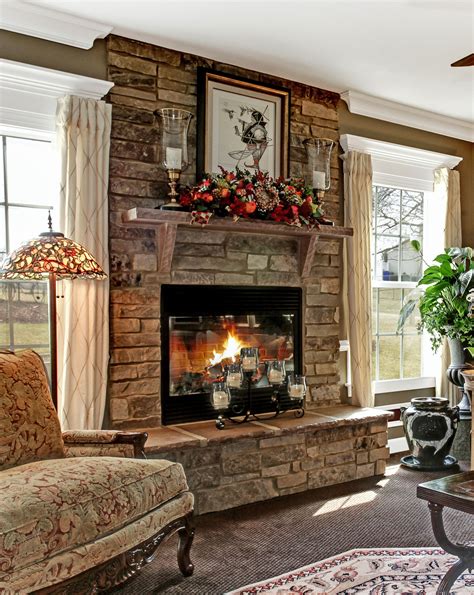 A stone fireplace adds a rustic element to an elegant room, making it a ...