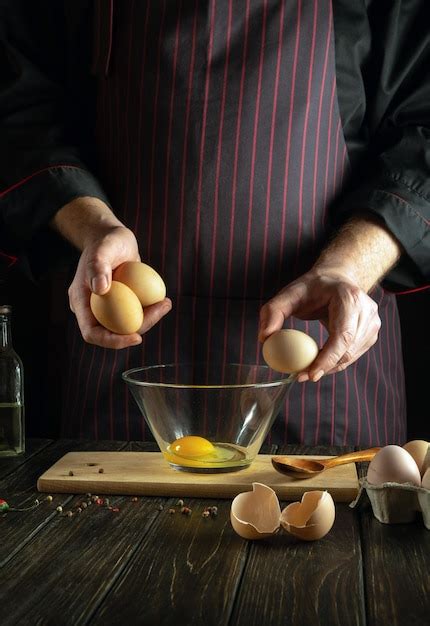 Premium Photo Professional Chef Prepares An Egg Omelette For Breakfast Working Environment In