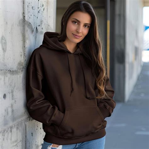 Premium Photo A Woman Wearing A Brown Hoodie Stands Against A Wall