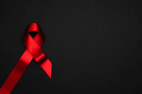 에이즈의 날 어두운 배경에 Hiv 세계 의 날에 빨간색 리본 기호 인식 보조 제 및 암 의료 및 의료 개념 0명에 대한 스톡