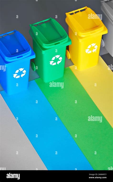 Three Color Coded Recycle Bins Isometric Projection On Layered Paper