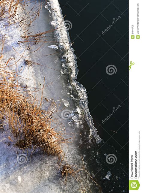 Ice Edge With Dry Reed On The Riverside In Winter View From Above