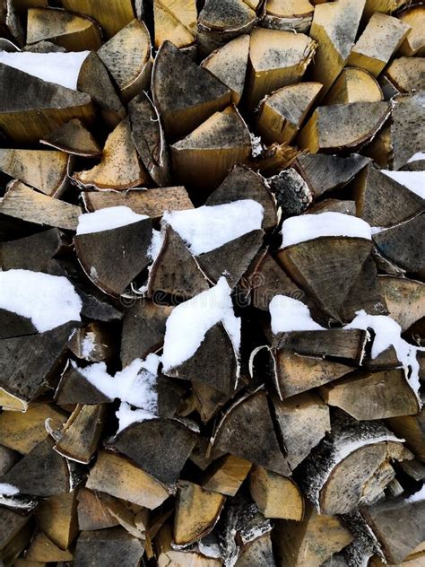 Firewood Stacked In Winter Chopped Stock Of Firewood Under Snow Stock