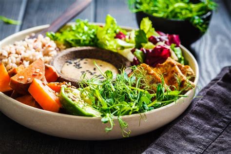 Buddha Bowl With Tofu Avocado Rice Seedlings Sweet Potato And Tahini Dressing Stock Image