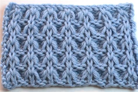 A Blue Crocheted Dishcloth On A White Surface