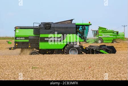 A Deutz - Fahr combine harvester at work harvesting a field of wheat ...