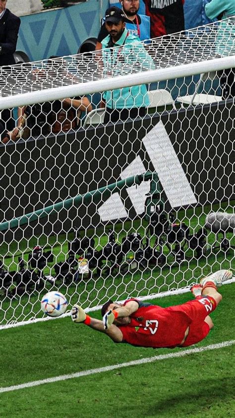 A Soccer Goalie Dives To Catch The Ball