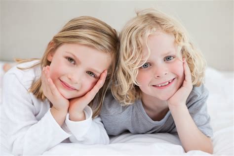 Premium Photo Brother And Sister Lying On The Bed