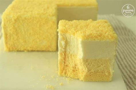 Two Pieces Of Yellow Cake Sitting On Top Of A White Plate Next To Each