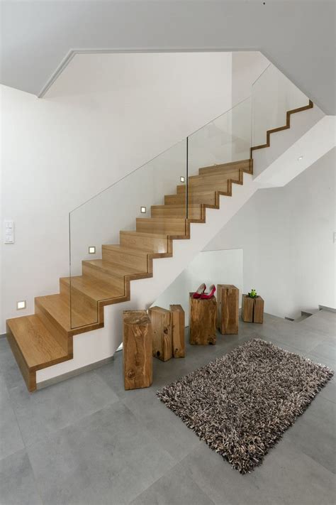 There Is A Carpet On The Floor Next To Some Wooden Steps In This Modern