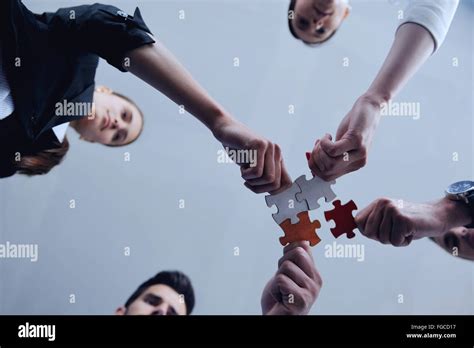 Group Of Business People Assembling Jigsaw Puzzle Stock Photo Alamy