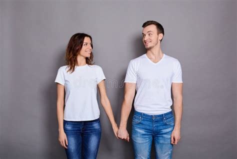 Romantic Couple Holds Hands And Look In Love At Each Other Stock Image