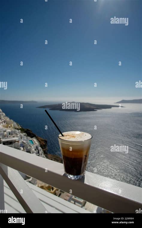 Panoramic View Of The Famous Caldera And An Iced Greek Coffee Also