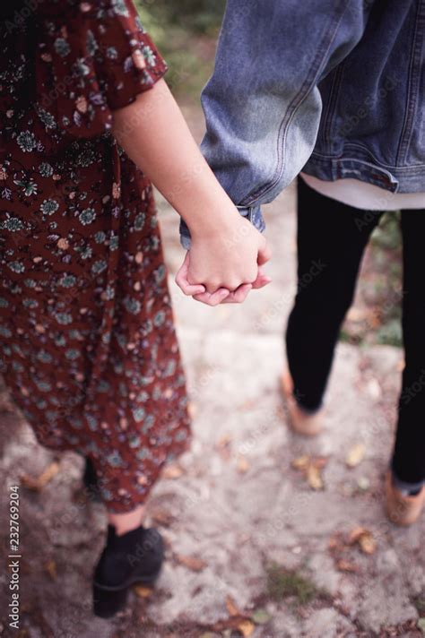 Teenage boy and girl with holding hands walking outdoors. Relationship. Love concept. Stock ...