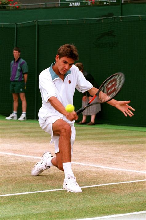 a male tennis player in action on the court