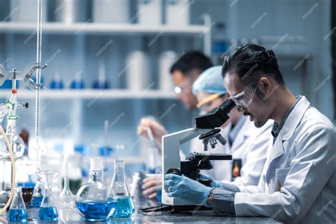 Premium Photo Young Scientist Looking Through A Microscope In A