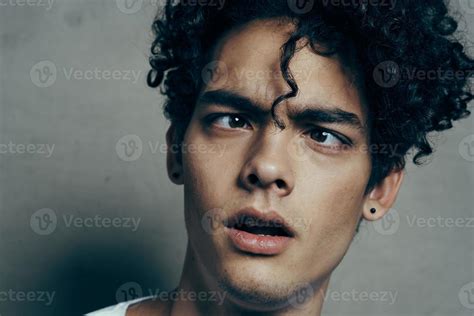 Portrait Of A Handsome Guy With Curly Hair On A Gray Background White T