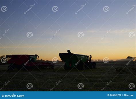 Silhouette of Combine Harvester on the Field in the Morning in Ontario ...