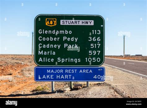 An Australian Road Sign With The Distances And Town Names Between