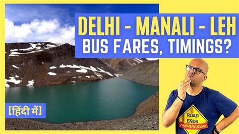 A Man Is Standing In Front Of A Mountain With A Sign That Says Delhi