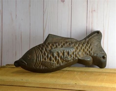 A Fish Statue Sitting On Top Of A Wooden Table