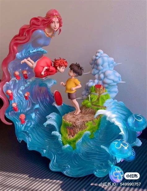 Two Figurines Are Standing On Top Of A Wave