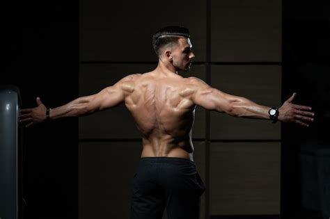 Premium Photo Muscular Man Flexing Back Muscles Pose