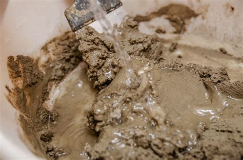 mixing cement  water closeup mixing  cement  water