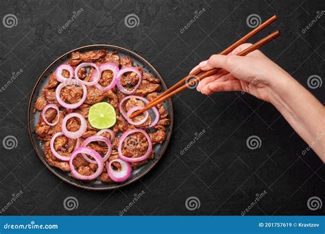 Bistek Tagalog Or Bistec Encebollado On Black Plate On Slate Table Top