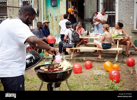 Friends Enjoying Backyard Barbecue Stock Photo Alamy