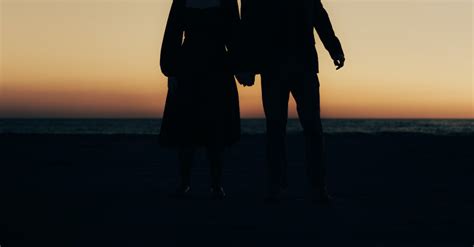 A Couple Holding Hands at Sunset · Free Stock Photo