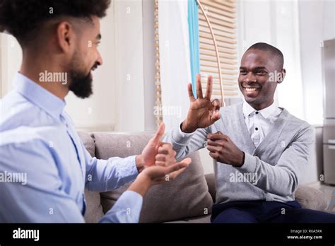 Two Happy Men Making Sign Language Stock Photo - Alamy